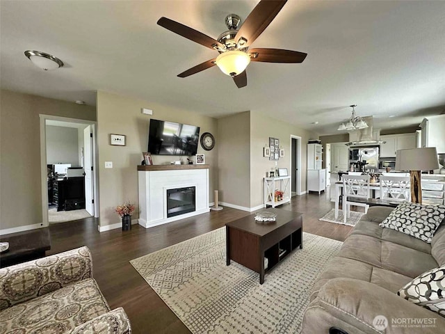 704 Roundtree Blvd, Winlock, WA 98596 - living room with a ceiling fan, a glass covered fireplace, and wood finished floors