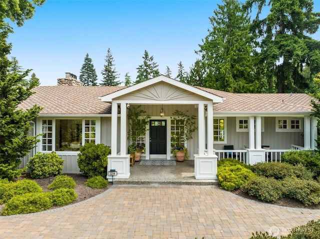 3204 Evergreen Point Rd, Medina, WA 98039 - ranch-style home featuring board and batten siding, a porch, a chimney, and roof with shingles