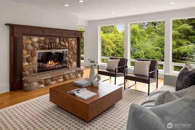 3204 Evergreen Point Rd, Medina, WA 98039 - living area with light wood-style flooring, a stone fireplace, ornamental molding, and recessed lighting