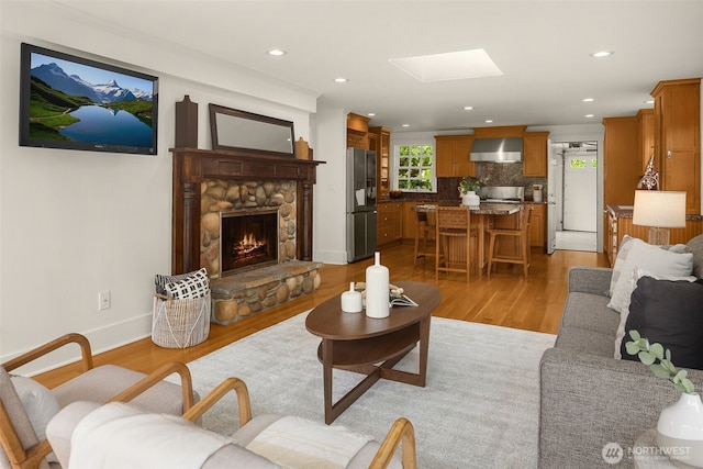 3204 Evergreen Point Rd, Medina, WA 98039 - living room with light wood-style floors, a stone fireplace, and recessed lighting