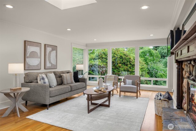 3204 Evergreen Point Rd, Medina, WA 98039 - living room featuring healthy amount of natural light, a fireplace, light wood-style floors, recessed lighting, and crown molding