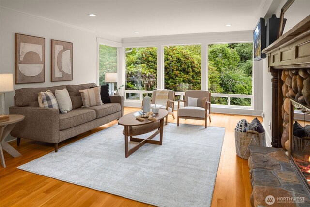 3204 Evergreen Point Rd, Medina, WA 98039 - living room with healthy amount of natural light, a fireplace, light wood finished floors, and ornamental molding