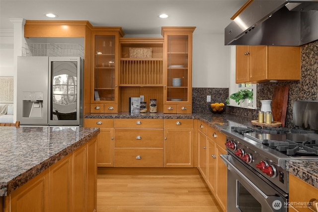 3204 Evergreen Point Rd, Medina, WA 98039 - kitchen featuring range hood, fridge with ice dispenser, high end range, light wood finished floors, and decorative backsplash