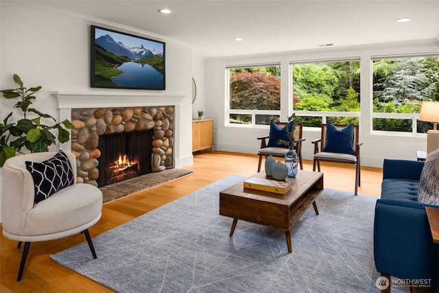 3204 Evergreen Point Rd, Medina, WA 98039 - living area featuring a stone fireplace, wood finished floors, recessed lighting, and ornamental molding
