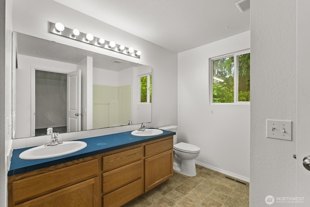 4327 Cedar Ct SE, Lacey, WA 98503 - bathroom featuring double vanity and toilet