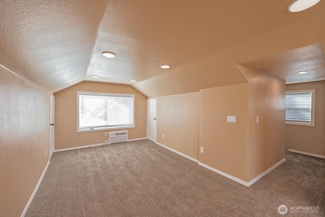 225 Basin St SW, Ephrata, WA 98823 - bonus room featuring lofted ceiling, carpet floors, a textured ceiling, and a wall mounted air conditioner
