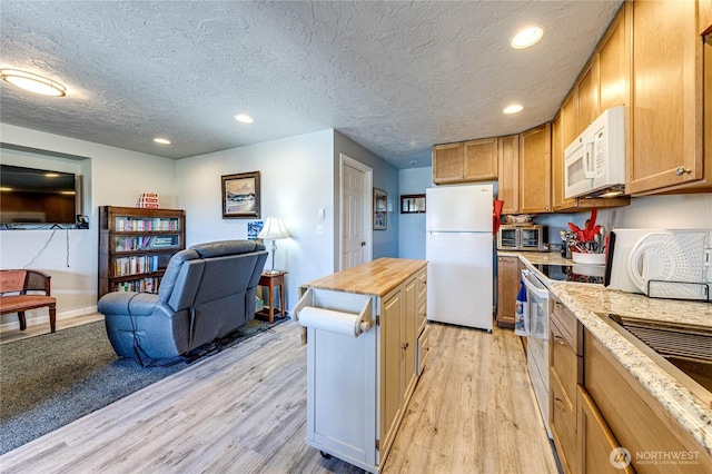 161 Lupine Dr, Sequim, WA 98382 - kitchen featuring white appliances, light wood-style floors, open floor plan, recessed lighting, and a kitchen island