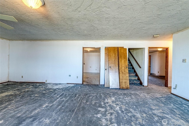 161 Lupine Dr, Sequim, WA 98382 - empty room featuring stairs, a textured ceiling, and baseboard heating
