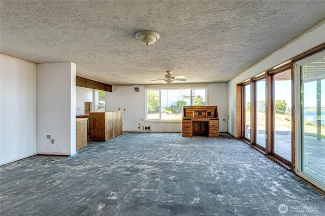 161 Lupine Dr, Sequim, WA 98382 - unfurnished living room featuring a ceiling fan and a textured ceiling