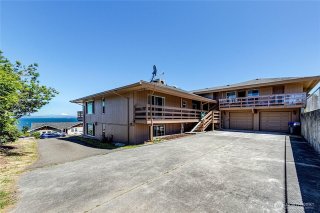 161 Lupine Dr, Sequim, WA 98382 - rear view of house with concrete driveway, stairs, and an attached garage