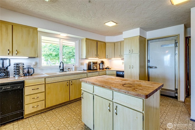 161 Lupine Dr, Sequim, WA 98382 - kitchen featuring black dishwasher, light brown cabinets, a center island, light flooring, and a textured ceiling