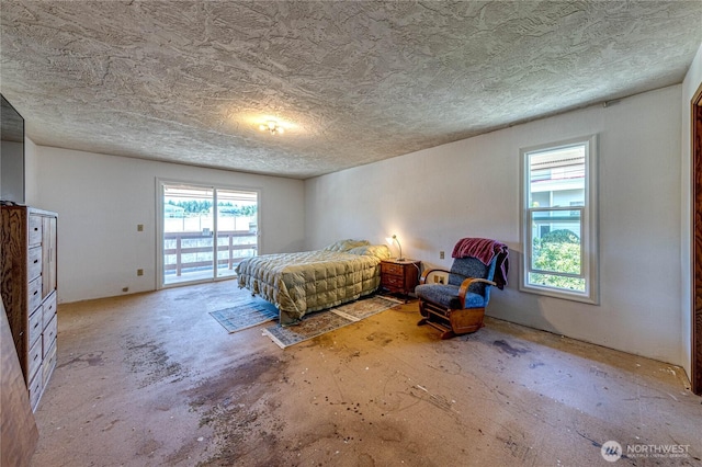 161 Lupine Dr, Sequim, WA 98382 - bedroom featuring concrete flooring, a textured ceiling, and access to outside