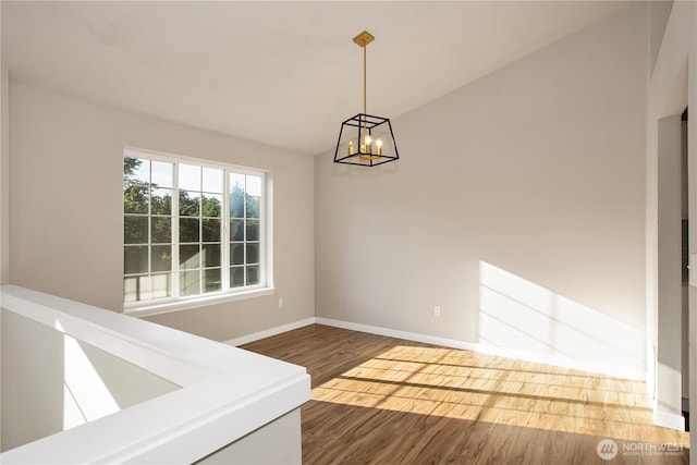 5814 Braywood Ln SE, Olympia, WA 98513 - unfurnished dining area featuring wood finished floors, a chandelier, and lofted ceiling