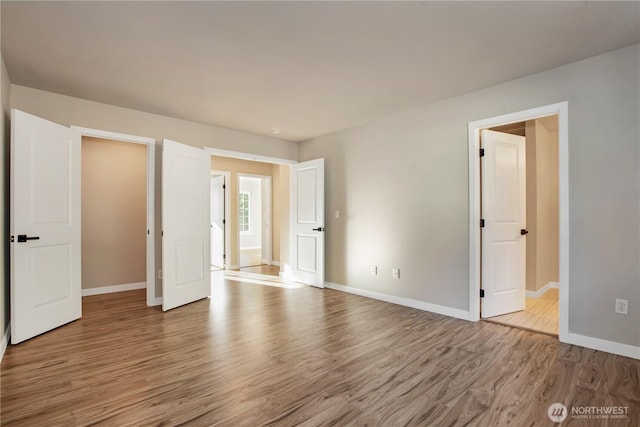 5814 Braywood Ln SE, Olympia, WA 98513 - unfurnished bedroom featuring wood finished floors and baseboards