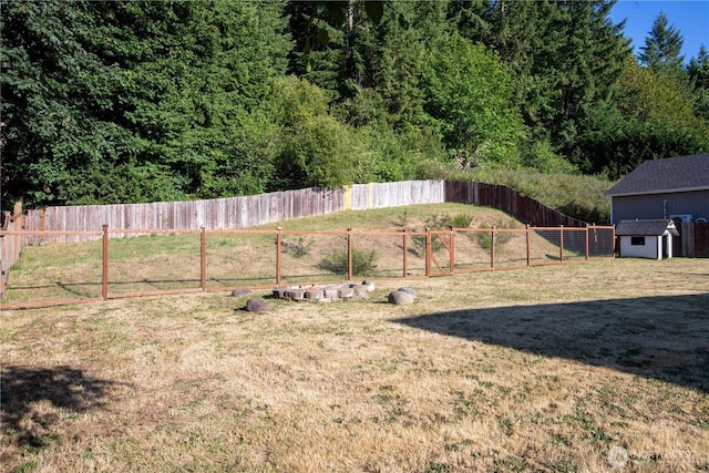 5814 Braywood Ln SE, Olympia, WA 98513 - fenced backyard featuring a storage unit and a view of trees