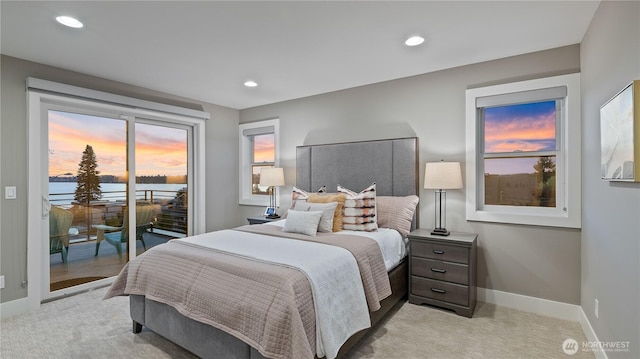 1006 4th St W, Kirkland, WA 98033 - bedroom with access to exterior, light colored carpet, a water view, and recessed lighting