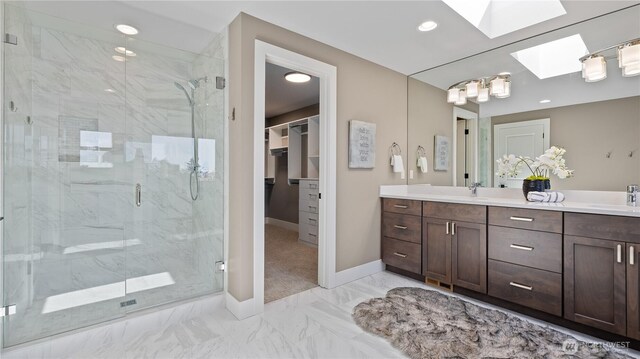 1006 4th St W, Kirkland, WA 98033 - bathroom featuring a skylight, double vanity, a marble finish shower, a spacious closet, and marble finish floors