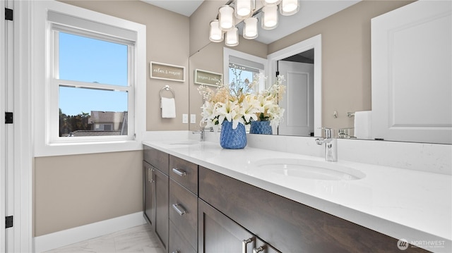 1006 4th St W, Kirkland, WA 98033 - bathroom featuring double vanity, healthy amount of natural light, and marble finish flooring