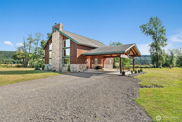 3146 State Route 508, Onalaska, WA 98570 - view of front of property featuring a chimney, a front yard, driveway, and stone siding