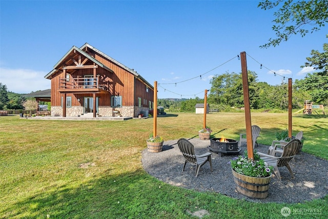 3146 State Route 508, Onalaska, WA 98570 - view of grassy yard with a fire pit, a playground, and a patio area