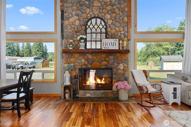 3146 State Route 508, Onalaska, WA 98570 - living area with hardwood / wood-style flooring, a stone fireplace, and healthy amount of natural light