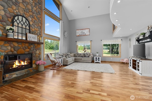 3146 State Route 508, Onalaska, WA 98570 - living area with high vaulted ceiling, wood finished floors, healthy amount of natural light, a stone fireplace, and recessed lighting