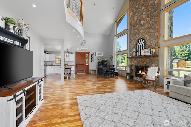 3146 State Route 508, Onalaska, WA 98570 - living area featuring high vaulted ceiling, light wood-style floors, a fireplace, and recessed lighting