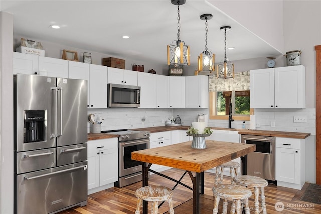 3146 State Route 508, Onalaska, WA 98570 - kitchen featuring premium appliances, wooden counters, tasteful backsplash, wood finished floors, and recessed lighting