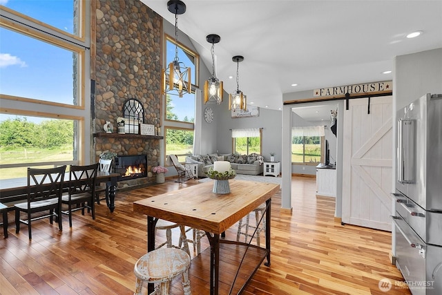 3146 State Route 508, Onalaska, WA 98570 - dining area featuring light wood-style flooring, a stone fireplace, recessed lighting, and high vaulted ceiling
