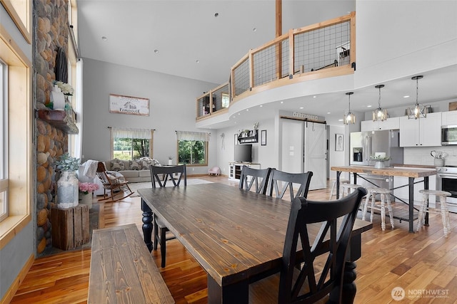 3146 State Route 508, Onalaska, WA 98570 - dining space with a barn door, a towering ceiling, and light wood finished floors