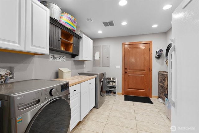 3146 State Route 508, Onalaska, WA 98570 - laundry area with cabinet space, recessed lighting, light tile patterned flooring, and washing machine and clothes dryer