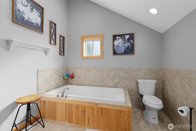 3146 State Route 508, Onalaska, WA 98570 - bathroom with a garden tub, vaulted ceiling, tile patterned floors, and tile walls