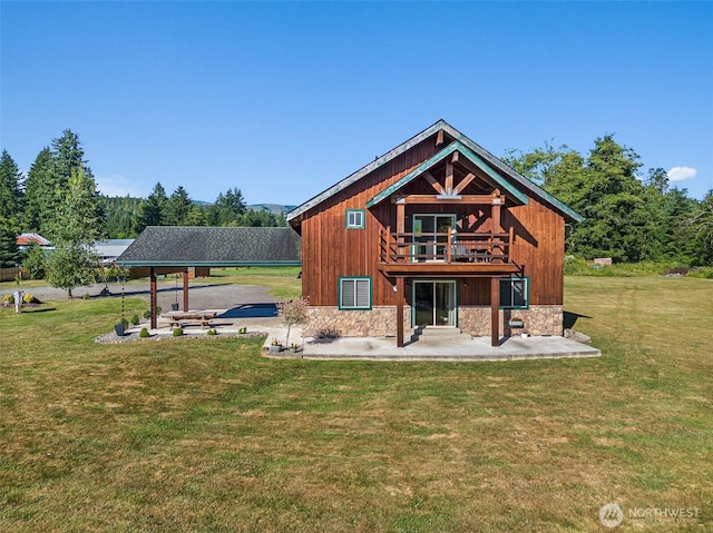 3146 State Route 508, Onalaska, WA 98570 - back of property featuring a lawn, a patio, a carport, stone siding, and a balcony