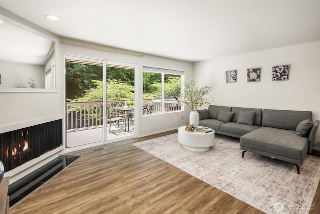 16932 NE 2nd Pl, Bellevue, WA 98008 - living room featuring wood finished floors, recessed lighting, and a warm lit fireplace