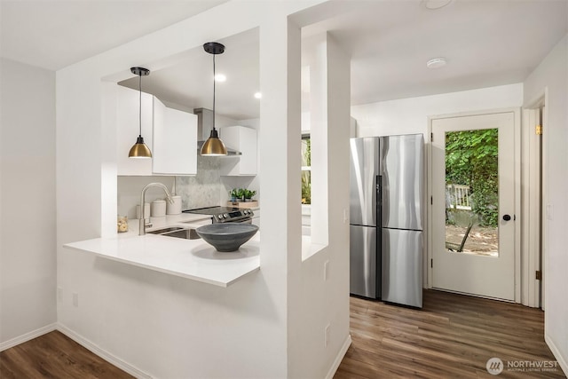 16932 NE 2nd Pl, Bellevue, WA 98008 - kitchen with stainless steel appliances, white cabinetry, tasteful backsplash, light countertops, and dark wood finished floors