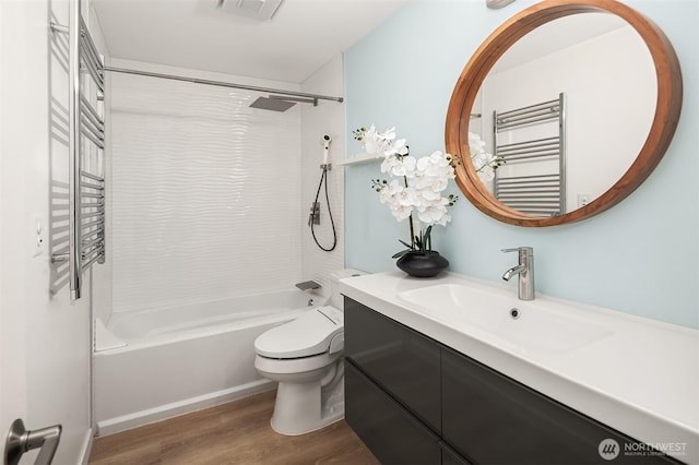 16932 NE 2nd Pl, Bellevue, WA 98008 - bathroom with a towel warmer, wood finished floors, radiator, tub / shower combination, and vanity
