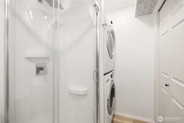 16932 NE 2nd Pl, Bellevue, WA 98008 - laundry area with stacked washer and clothes dryer and light wood-type flooring