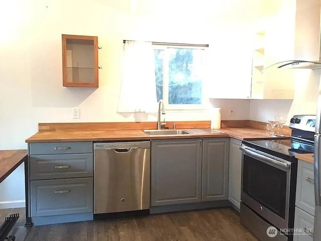 1750 NW 58th St, Seattle, WA 09107 - kitchen featuring appliances with stainless steel finishes, gray cabinets, island exhaust hood, butcher block countertops, and dark wood-style floors