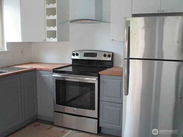 1750 NW 58th St, Seattle, WA 09107 - kitchen with appliances with stainless steel finishes, island exhaust hood, butcher block counters, gray cabinetry, and glass insert cabinets