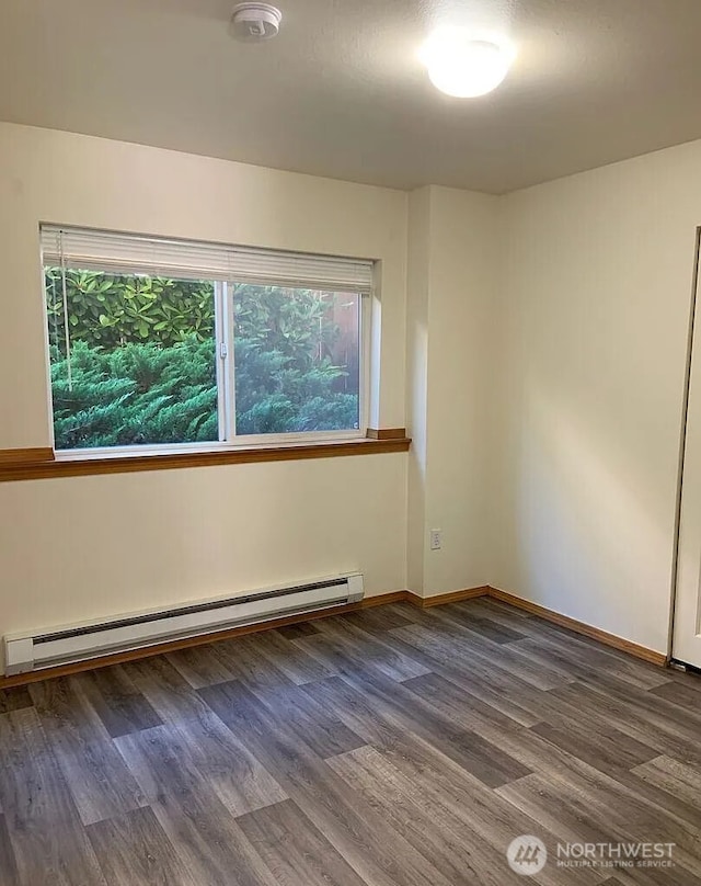1750 NW 58th St, Seattle, WA 09107 - unfurnished room with a baseboard radiator, wood finished floors, and a smoke detector