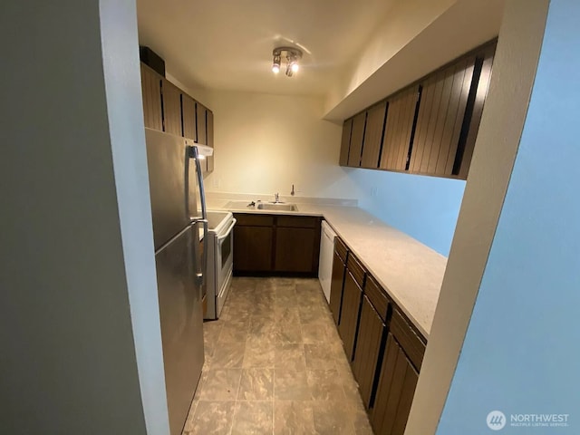 1750 NW 58th St, Seattle, WA 09107 - kitchen with freestanding refrigerator, white electric range oven, light countertops, and dark brown cabinetry