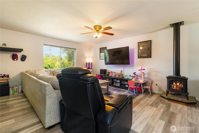 1390 Jordan Ct, Oak Harbor, WA 98277 - living area with a wood stove, a ceiling fan, and light wood-style flooring