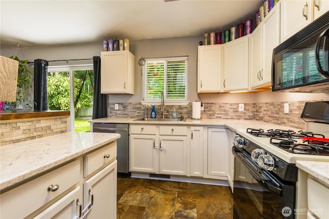 1390 Jordan Ct, Oak Harbor, WA 98277 - kitchen with black appliances, healthy amount of natural light, tasteful backsplash, and white cabinetry