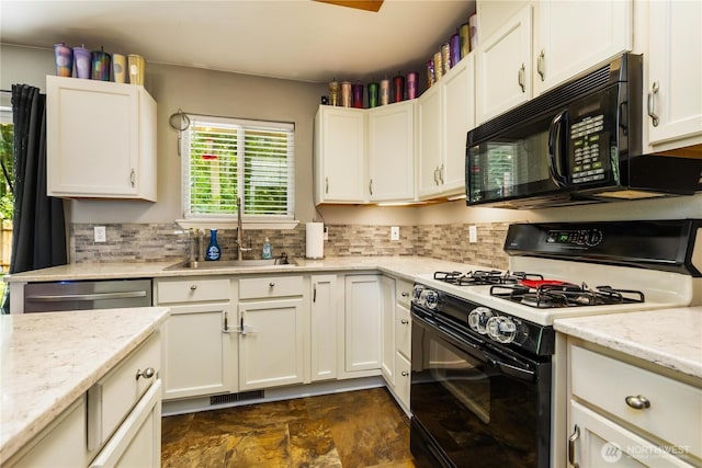 1390 Jordan Ct, Oak Harbor, WA 98277 - kitchen with black appliances, backsplash, white cabinets, and stone finish floors