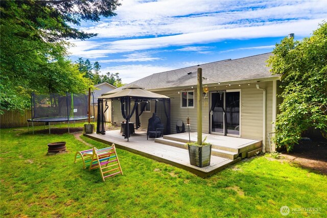 1390 Jordan Ct, Oak Harbor, WA 98277 - back of property with a gazebo, a trampoline, and a deck