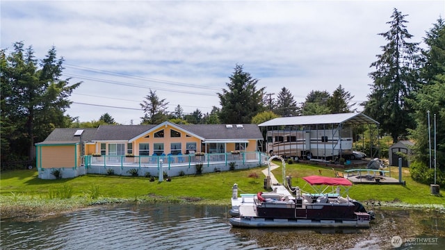 118 Ocean Lake Way NE, Ocean Shores, WA 98569 - back of property featuring a yard, an outdoor fire pit, a water view, and a storage shed