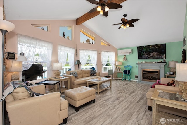 118 Ocean Lake Way NE, Ocean Shores, WA 98569 - living area with a ceiling fan, beam ceiling, high vaulted ceiling, light wood-style floors, and a fireplace