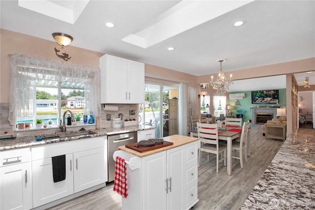 118 Ocean Lake Way NE, Ocean Shores, WA 98569 - kitchen with stainless steel dishwasher, white cabinets, a chandelier, backsplash, and recessed lighting