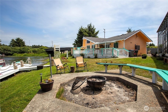 118 Ocean Lake Way NE, Ocean Shores, WA 98569 - view of patio / terrace featuring an outdoor fire pit, a boat dock, and a deck with water view