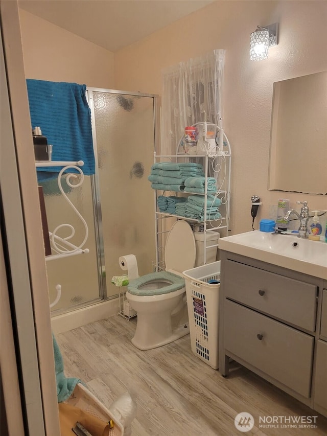 118 Ocean Lake Way NE, Ocean Shores, WA 98569 - bathroom featuring wood finished floors, vanity, and a shower stall